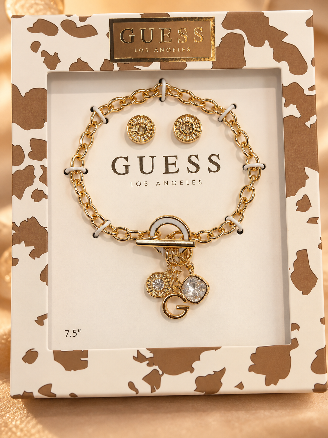 Set pulsera y aretes Guess dorada